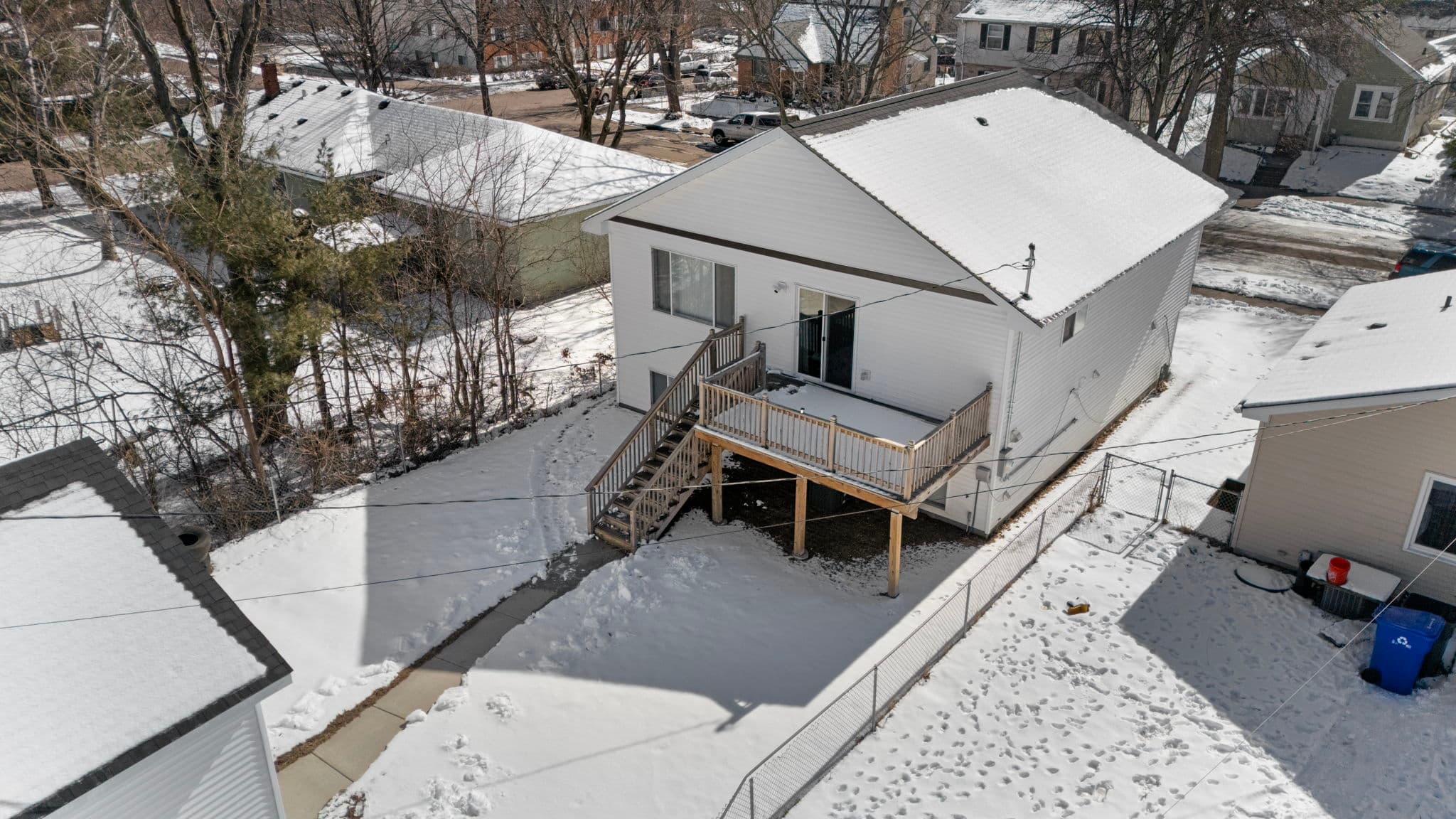 Aerial view of the back deck, fenced yard, and sliding patio door