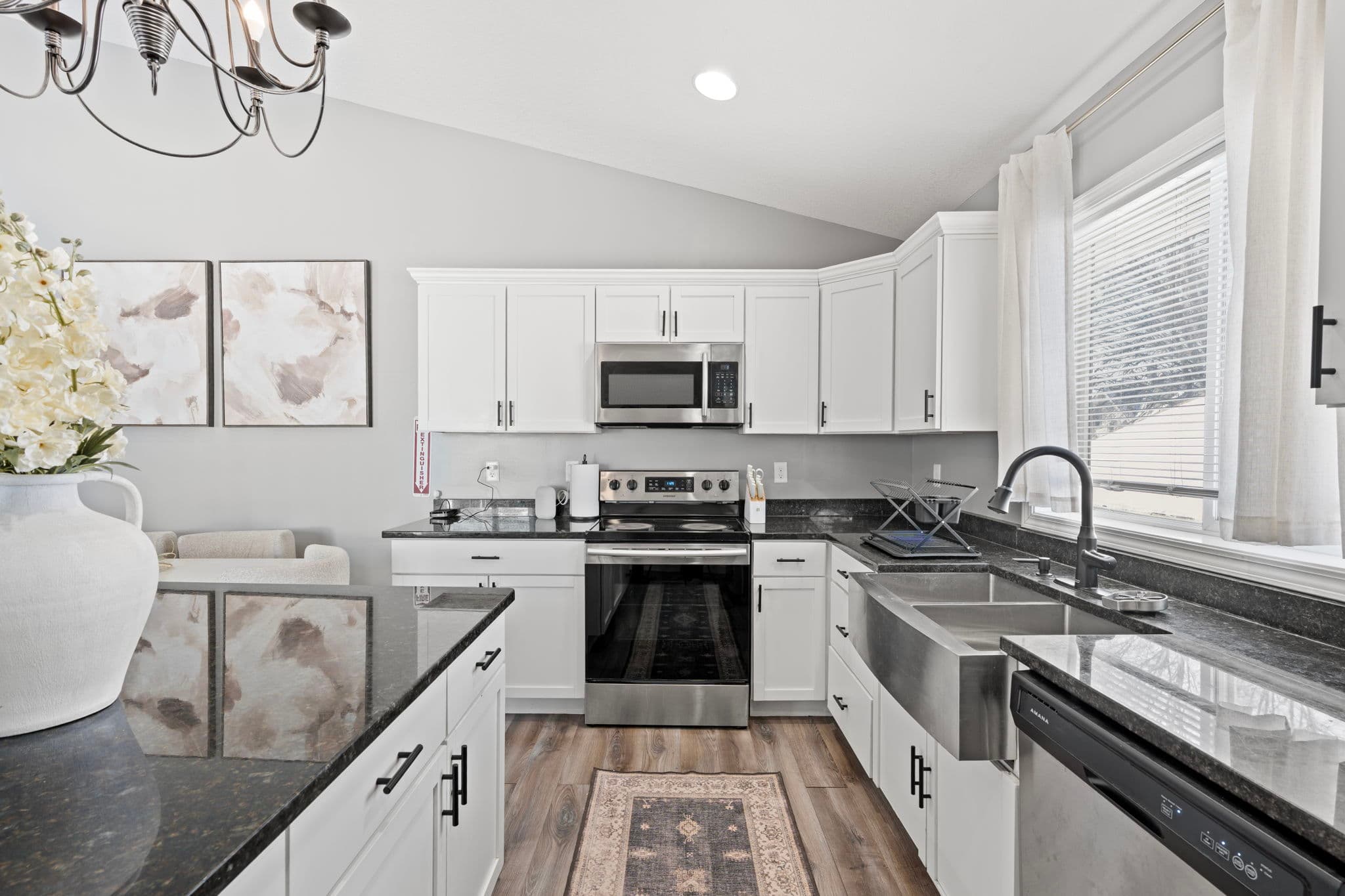 Stainless electric range with over-range microwave and farmhouse sink